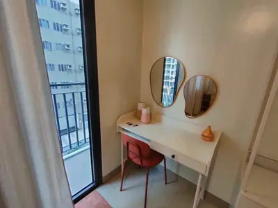 a bathroom with a vanity with two mirrors and a window at shore 1bedroom with balcony in Manila