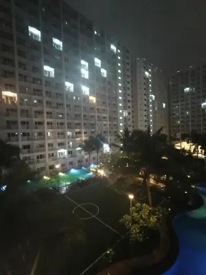 a view of a city at night with tall buildings at Shore residences Tower D pool view Unit in Manila