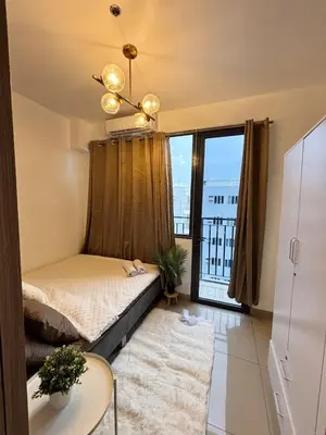 a bedroom with a bed and a large window at Staycation by the Shore in Manila