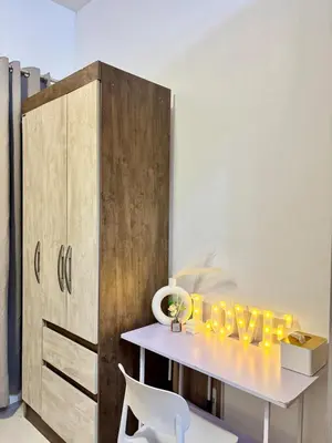 a table with a yellow sign on it next to a cabinet at Relaxing City Retreat in Manila