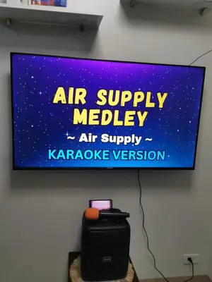 a sign on a wall that reads air supply needle air supply karaoke convention at Mall of Asia residence Shore 3 in Manila