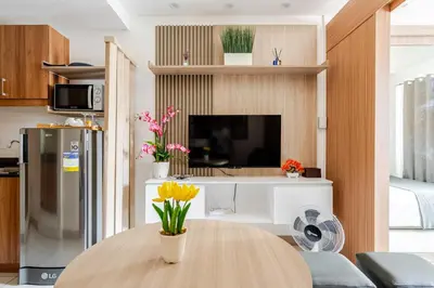 a kitchen with a table with flowers on it at Relaxing 1BR condo with Pool and Balcony in Makati in Manila