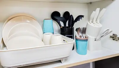 a kitchen counter with a tray of utensils at MOA Staycation at Shore 2 Residences Tower 1 in Manila