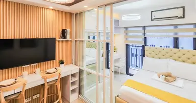 a room with a tv and a bed and a table at MOA Staycation at Shore 2 Residences Tower 1 in Manila