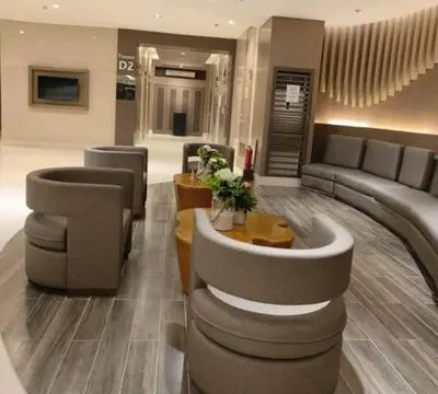 a lobby with a couch and chairs and a table at Pasay MOA Manila Bay Shore Residences Dynastel Staycation 1828 in Manila