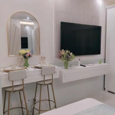 a white bathroom with a television and two stools at Homefort Twin Bed Suite - Red Residences Unit 2626 in Manila