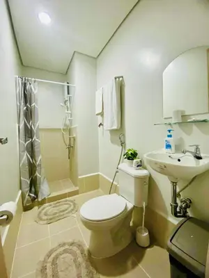 a bathroom with a toilet and a sink and a shower at SMDC Park Residences Condo Unit 417 near SM City Sta Rosa in Ibaba