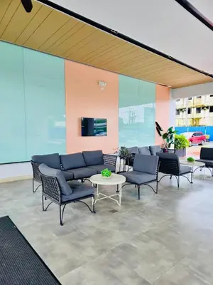 a lobby with chairs and a table in a building at SMDC Park Residences Condo Unit 417 near SM City Sta Rosa in Ibaba