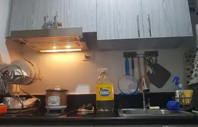 a kitchen with a sink and a counter top with a sink at Cozy Coast Residences Pasay in Manila