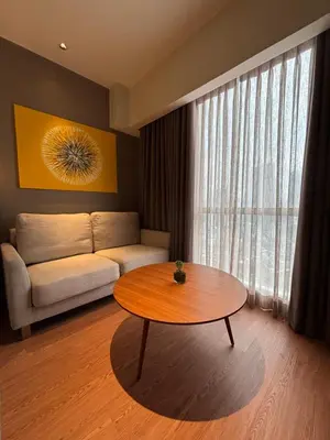 a living room with a coffee table and a couch at The hotel residences at Acqua in Manila