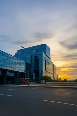 a large glass building with a sunset in the background at Ultra Luxury 6 Bedroom beside Solaire, Okada in Manila