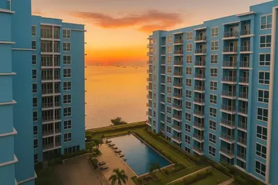 a view of two tall buildings with a sunset in the background at Ultra Luxury 6 Bedroom beside Solaire, Okada in Manila