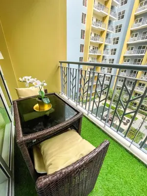 a balcony with a table and chairs on a balcony at Luxury 4 Bedroom Luxury Suite near Solaire & Okada in Manila