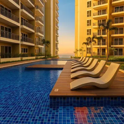 a row of chairs sitting on a wooden deck next to a swimming pool at Elegant 2 Bedroom Suite near Solaire, Okada in Manila