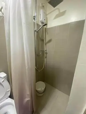 a bathroom with a shower and a toilet at Shore Residences Tower D # 408 in Manila