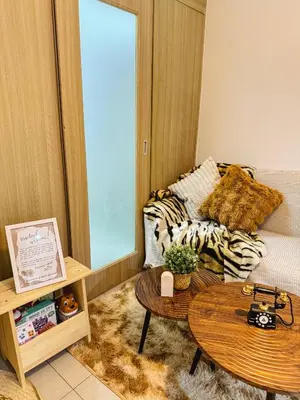 a living room with a couch and a table at Staycation near MOA Pasay at Shore Residences - Elizcape in Manila