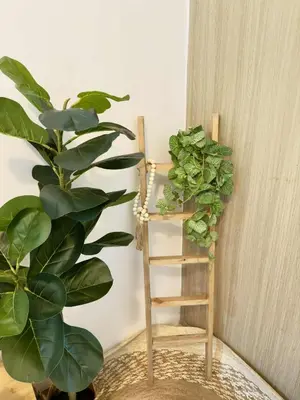 a wooden ladder next to a plant in a room at Staycation near MOA Pasay at Shore Residences - Elizcape in Manila