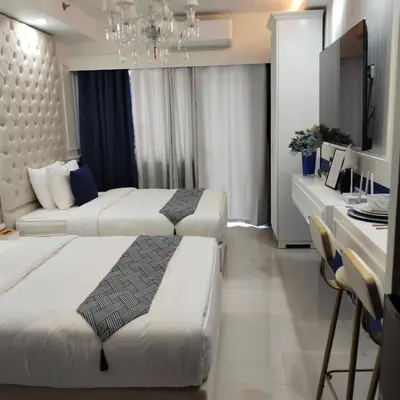 a hotel room with two beds and a desk at Homefort Twin Bed Suite - Red Residences Unit 2649 in Manila