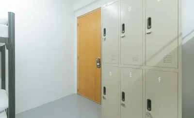 a locker room with lockers and a door at RedDoorz at Qhouzz near PUP in Manila