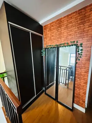 a room with glass doors and a brick wall at Newly Renovated 2-storey Loft at Greenbelt 1 Near Legaspi Park in Manila