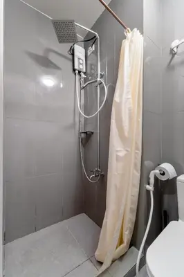 a shower with a shower curtain in a bathroom at 1BR Staycation at AIR Residences Makati City in Manila
