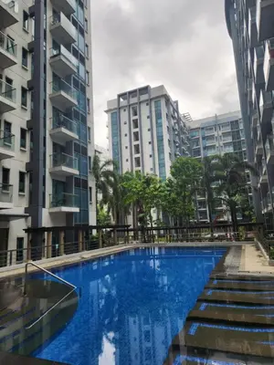 a swimming pool in the middle of some buildings at Staycation By JEM - Across NAIA T3 in Newport City in Manila