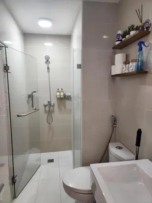 a bathroom with a shower and a toilet at Staycation By JEM - Across NAIA T3 in Newport City in Manila
