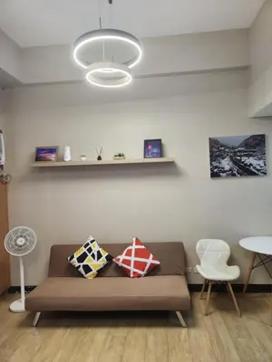 a living room with a couch and a table at Staycation By JEM - Across NAIA T3 in Newport City in Manila