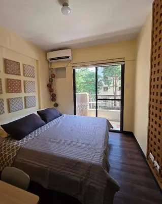 a bedroom with a large bed and a large window at The Yanoa Stay 2 Bedroom Condo in Manila