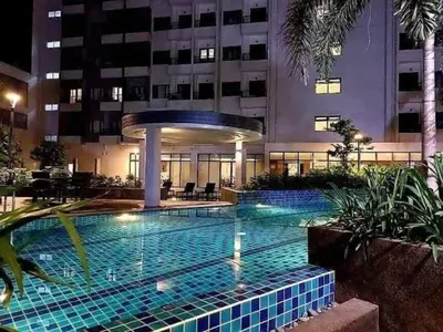 a large swimming pool in front of a building at Sky Suites at Spring Residences Condotel near NAIA and SM Bicutan Mall in Manila
