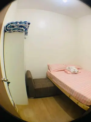a small bedroom with a bed in a wall at Sky Suites at Spring Residences Condotel near NAIA and SM Bicutan Mall in Manila