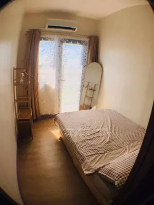 a bedroom with a bed in front of a window at Sky Suites at Spring Residences Condotel near NAIA and SM Bicutan Mall in Manila
