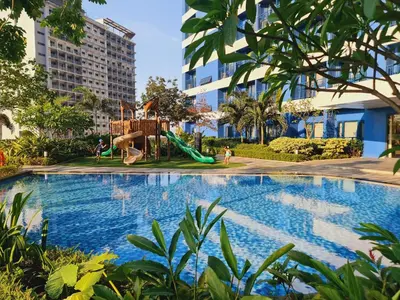 a swimming pool with a playground and a slide at Air Residences- Netflix with City View in Manila