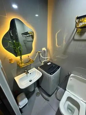 a bathroom with a sink and a toilet and a mirror at Air Residences- Netflix with City View in Manila