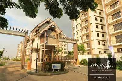 a building in front of a tall building at Arista Place 2 bedroom Condo near airport in Manila