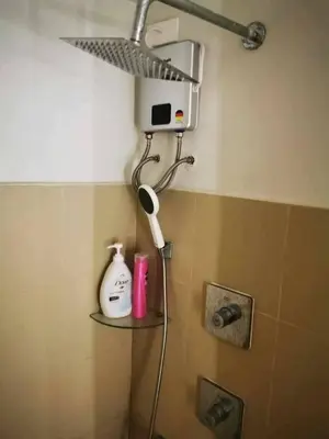a shower in a bathroom with a shower head at Mall of Asia gateways shore 3 condotel in Manila