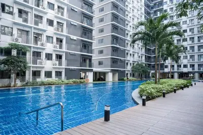 a large swimming pool in front of a building at Mall of Asia gateways shore 3 condotel in Manila