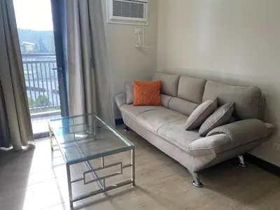 a living room with a couch and a glass table at 2-min Walk to Okada Near AirportMOA wBalcony in Manila