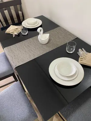 a table with two plates and a swan on it at 2-min Walk to Okada Near AirportMOA wBalcony in Manila