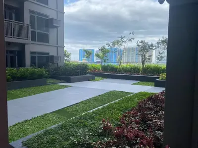 a view of a garden with a building at 2-min Walk to Okada Near AirportMOA wBalcony in Manila