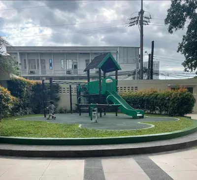 a playground with a green slide in a park at LA VERTI 1B MINIMALIST AFFORDABLE STAYCATION IN PASAy in Manila