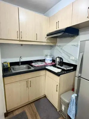 a small kitchen with a sink and a refrigerator at LaVerti 1BR Affordable staycation groups family in Manila