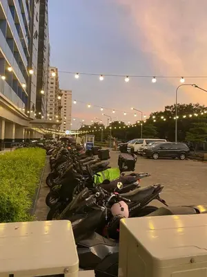 a row of motorcycles parked in a parking lot at Scarlet Stay in Manila