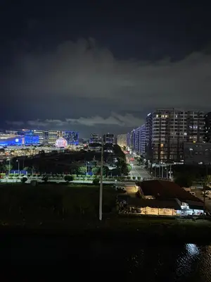 a city lit up at night with buildings at Bayhaus MNL - Pet-friendly Condo near MOA in Manila