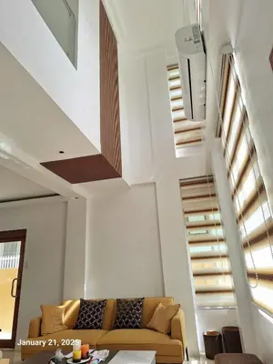 a living room with a couch and stairs at Brand New Home! 3BR, 5 Beds, 3 Baths, Full AC in San Agustin