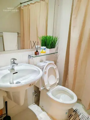 a bathroom with a toilet and a sink at Natalie Staycation Buddies in Manila