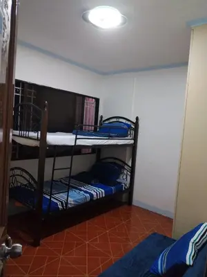 a room with two bunk beds in a room at male bedspace in Manila