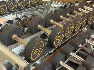 a row of dumbbells in a gym at Place in Century Poblacion in Manila