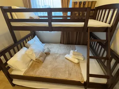 a bunk bed with two sets of towels on it at Modern Spacious 2BR 68 sqm Condo in Manhattan Heights Pool View in Manila