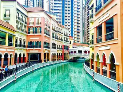 a river in the middle of a city with buildings at Affordable Condo Suite with WIFI in McKinley BGC in Manila